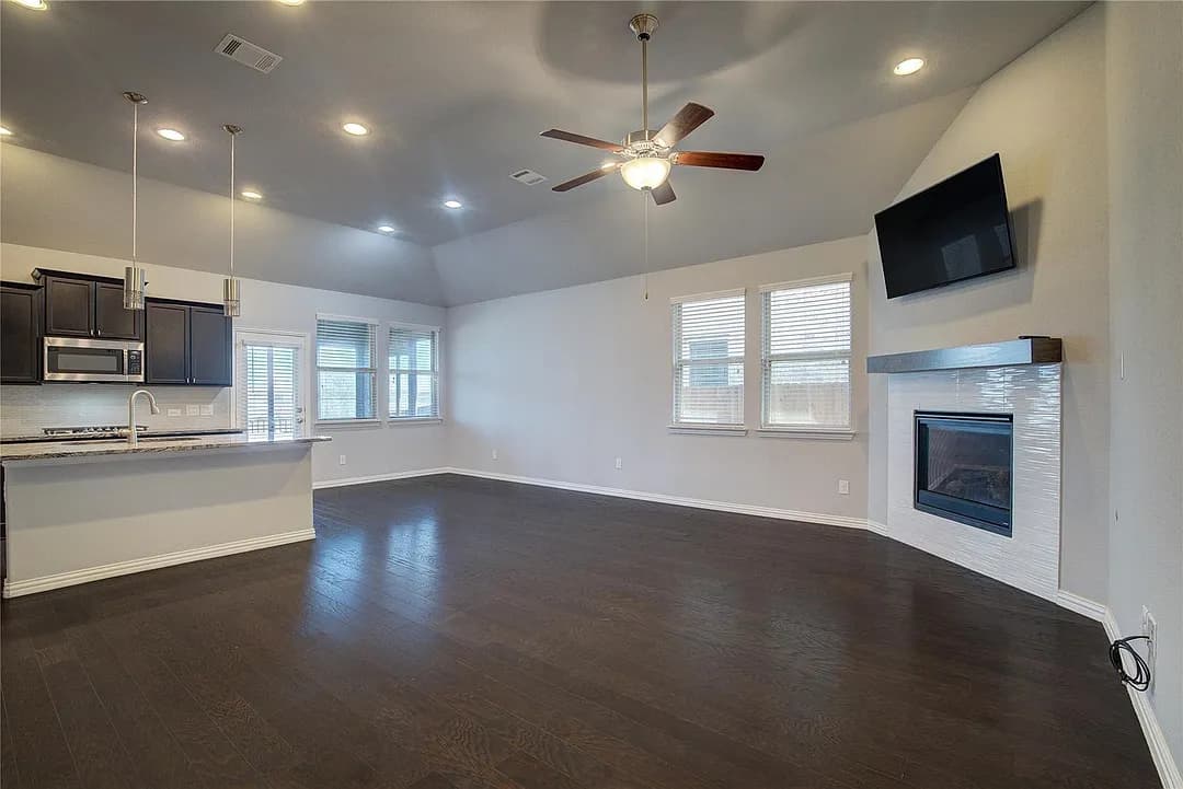 Empty living room with an open kitchen and fireplace in the Garland rental